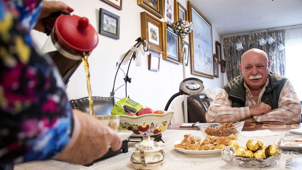 Alla Sheherbi pours tea for her husband, Simon Kaganov, in their home at Windsor Gardens, Nov. 16, 2019. (Kevin J. Beaty/Denverite)