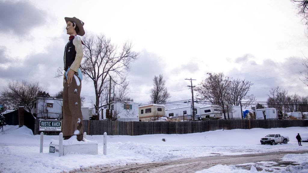 John Sutton's giant, nameless cowboy which guards Rustic Ranch Mobile Home and RV Park off Federal Boulevard. Nov. 26. 2019. (Kevin J. Beaty/Denverite)