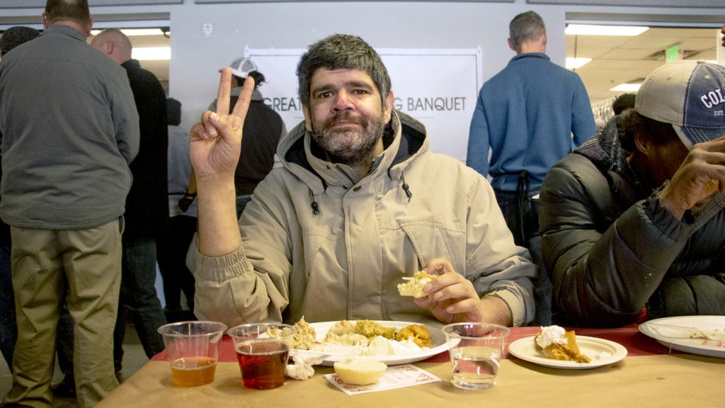 Edward Barela poses for a portrait as he eats a Thanksgiving dish at the Denver Rescue Mission, Nov. 27, 2019. (Kevin J. Beaty/Denverite)