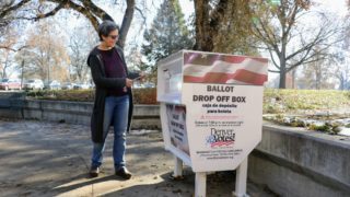 Jessica Cohen casts her ballot at a drop box in Washington Park. Nov. 5, 2019. (Kevin J. Beaty/Denverite)