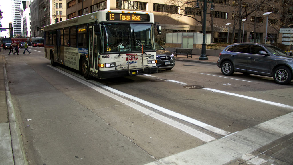 An RTD bus drives down a freshly-painted bus lane on 17th Avenue downtown. Dec. 13, 2019. (Kevin J. Beaty/Denverite)