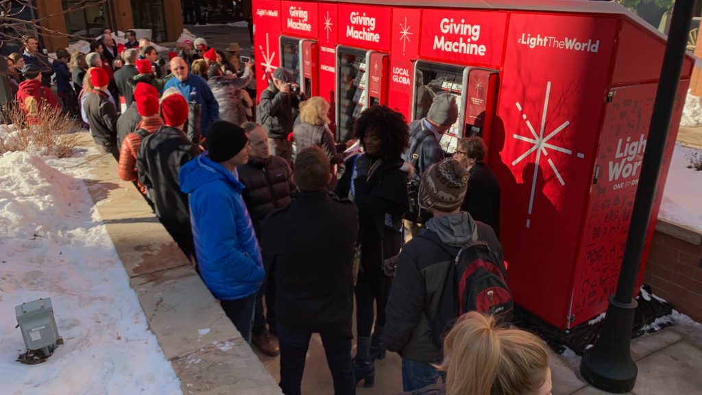 People gathered outside the Giving Machine at Writer Square on Monday, Dec. 2, in downtown Denver. (Esteban L. Hernandez/Denverite)