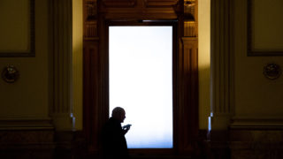 A man talks into a phone at the state Capitol building, Jan. 6, 2020. (Kevin J. Beaty/Denverite)