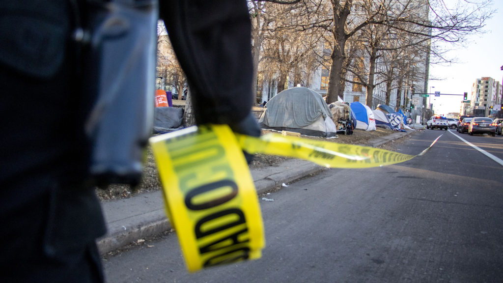 Denver Department of Public Health and Environment workers break up an encampment at Lincoln Memorial Park due to a "public health and safety risk," Jan. 15, 2020. (Kevin J. Beaty/Denverite)