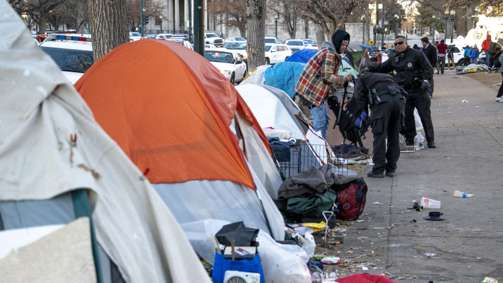 Denver Department of Public Health and Environment workers break up an encampment at Lincoln Memorial Park due to a "public health and safety risk," Jan. 15, 2020. (Kevin J. Beaty/Denverite)