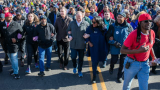 Denver School Board Member Tay Anderson, Secretary of State Jena Griswold, Mayor Michael Hancock, Former Governor John Hickenlooper, Governor Jared Polis, Rep. Leslie Herod, and former Philadelphia Mayor Michael Nutter joined arms at the 2020 Marade marking the Martin Luther King Jr. holiday in Denver, Jan. 20, 2020.