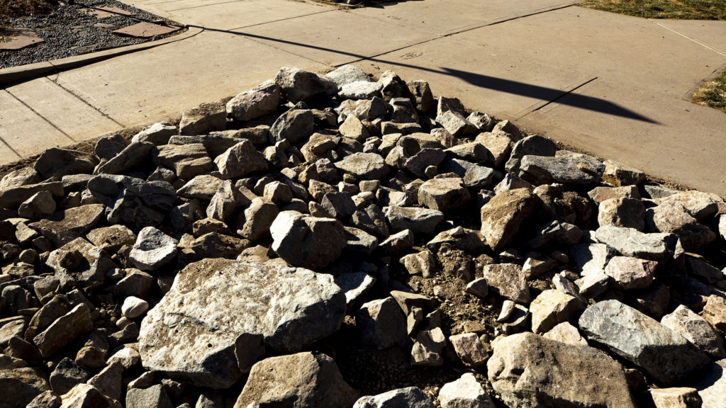 A building is surrounded by chunks of concrete in Five Points on Jun. 28, 2020. (Kevin J. Beaty/Denverite)