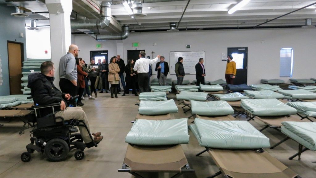 Denver City Council members along with council and city staff members during a stop at the main existing shelter for women, run by Catholic Charities on Smith Road on Jan. 9. 2020. (Donna Bryson/Denverite)