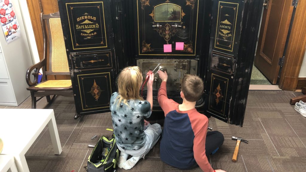Chloe Clark, 11, and Logan Clark, 13, work to open a safe inside their father Councilman Jolon Clark's office on Monday, Jan. 6, in Denver. (Photo Courtesy of Councilman Jolon Clark)