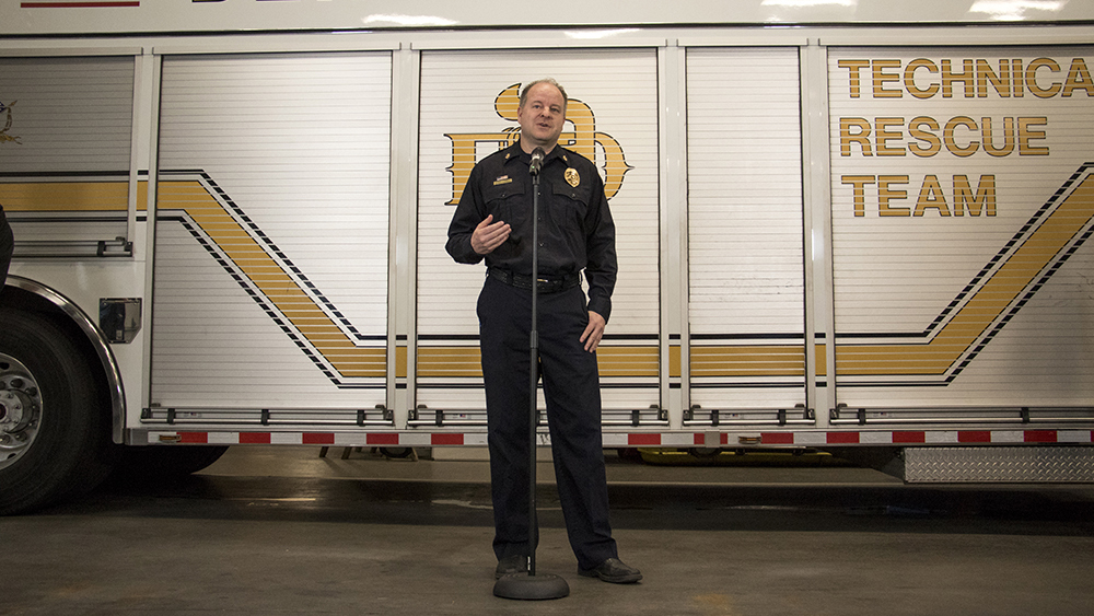 Denver Fire Department Chief Eric Tade introduces Cora, the accelerant-sniffing dog, as she's officially welcomed to her new job, May 3, 2018. (Kevin J. Beaty/Denverite)