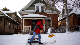 A man named "T-Bone" Terry shovels a sidewalk on snowy day in West Highland, Feb. 4, 2020. (Kevin J. Beaty/Denverite)