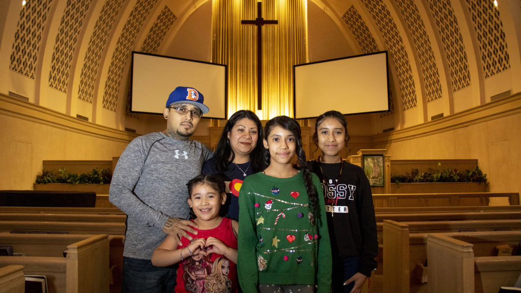 Jorge Ávila, his wife, Alejandra, and their daughters, Sherlyn, Zaira and Fatima, pose for a portrait inside Park Hill United Methodist Church's sancturary. Feb. 11, 2020. (Kevin J. Beaty/Denverite)
