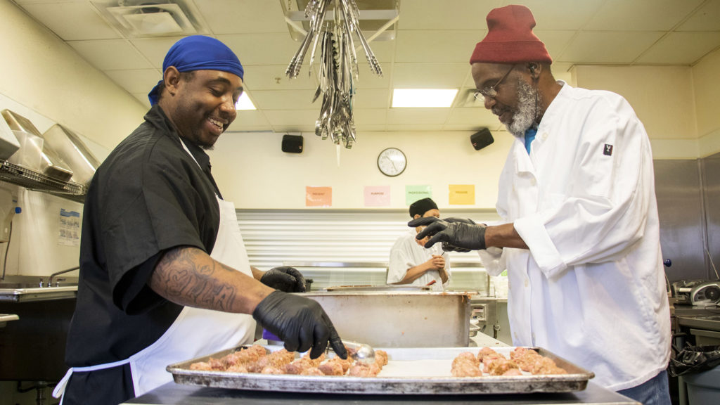 Future Honesty (left) and James Walker work in the kitchen at the Mental Health Center of Denver, Feb. 13, 2020. (Kevin J. Beaty/Denverite)