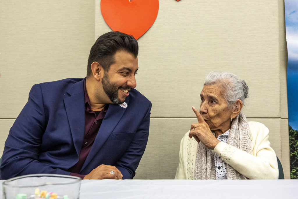 Denver clerk and recorder Paul López chats with Doña Dolores Valles, whose granddaughter is about to get married, February 14, 2020. (Kevin J. Beaty / Denverite)