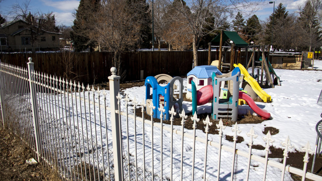 A kiddie playground in a yard next to Westwood Park, Feb. 18, 2020. (Kevin J. Beaty/Denverite)