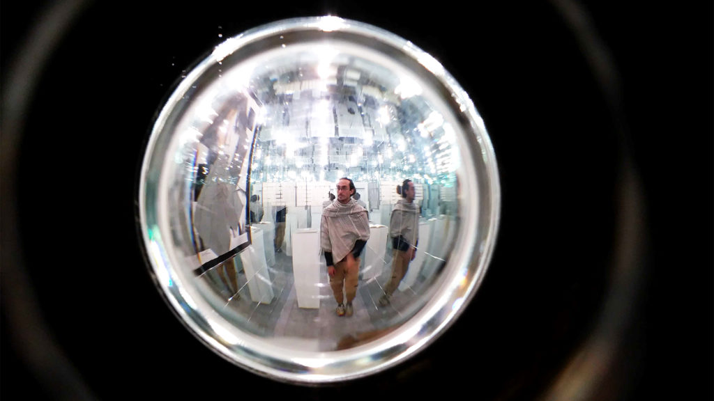 A look through a peephole into a room of mirrors, part of Devon Dikeou's "Mid-Career Smear" exhibition at her downtown art space. Feb. 20, 2020. (Kevin J. Beaty/Denverite)