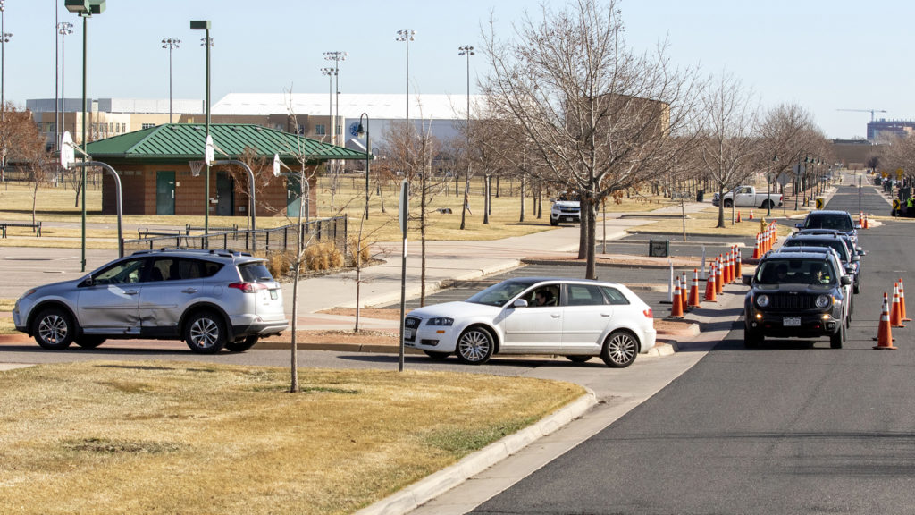 Cars line up as people wait to be tested at the Colorado Department of Health and Environment's COVID-19 testing station in Lowry. March 11, 2020. (Kevin J. Beaty/Denverite)