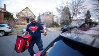 Julian Rai drops off a Grubhub order on a Friday evening. March 13, 2020. (Kevin J. Beaty/Denverite)