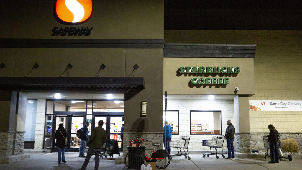 People wait to enter the Safeway on 20th Avenue as it opens for the day. March 18, 2020. (Kevin J. Beaty/Denverite)