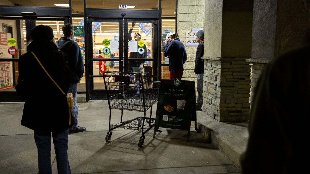 People wait to enter the Safeway on 20th Avenue as it opens for the day. March 18, 2020. (Kevin J. Beaty/Denverite)
