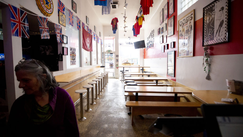 Solange Zanetti waits for a to-go order inside GB Fish and Chips on Colfax Avenue. March 21, 2020. (Kevin J. Beaty/Denverite)