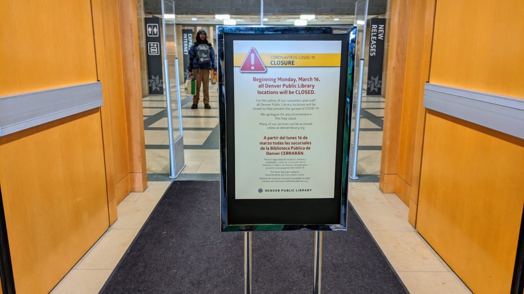 A sign posted Friday, March 13, 2020 at the entrance to Denver's main library announces the facility will be closed indefinitely starting Monday, March 16, 2020 because of coronavirus. (Donna Bryson/Denverite)