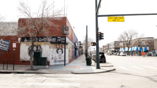 Mutiny Information Cafe is boarded up and covered with paint on Broadway. April 1, 2020. (Kevin J. Beaty/Denverite)