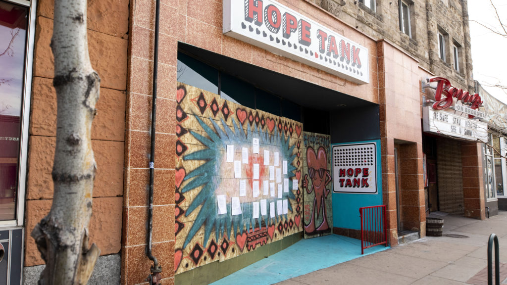 Hope Tank on Broadway is boarded up, but covered with paint and poems, April 1, 2020. (Kevin J. Beaty/Denverite)