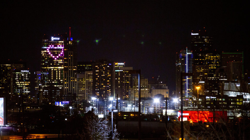 The Optiv building at 15th and Arapahoe Streets is lit up with a pink heart. April 3, 2020. (Kevin J. Beaty/Denverite)
