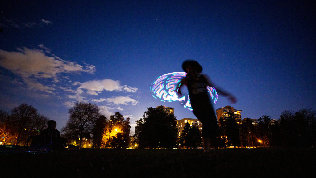 Heather Farley whips a hula hoop around her body in Cheesman Park. April 7, 2020. (Kevin J. Beaty/Denverite)