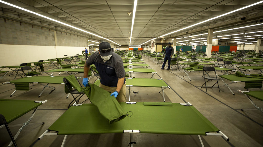 Nick Jurkowski, a United Airlines employee, volunteers to help transform the National Western Center into a shelter for unhoused men. April 8, 2020. (Kevin J. Beaty/Denverite)
