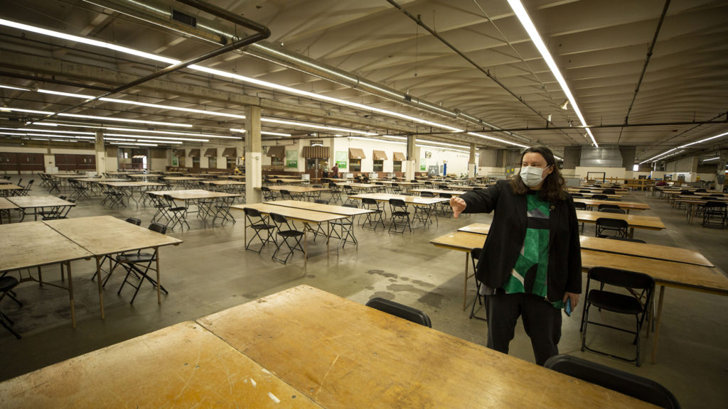 Britta Fisher, executive director of Denver's Department of Housing Stability, gives a tour of a men's shelter being constructed at the National Western Complex. April 8, 2020. (Kevin J. Beaty/Denverite)