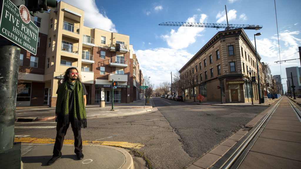 Ryan Foo poses in Five Points by the shuttered Crossroads Theater where the Black Actors Guild once held court. April 9, 2020. (Kevin J. Beaty/Denverite)
