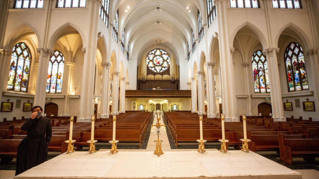 Hung Pham, director of litergy for the Archdiocese of Denver, wears a mask before Easter mass at the Cathedral Basilica of the Immaculate Conception. April 12, 2020. (Kevin J. Beaty/Denverite)