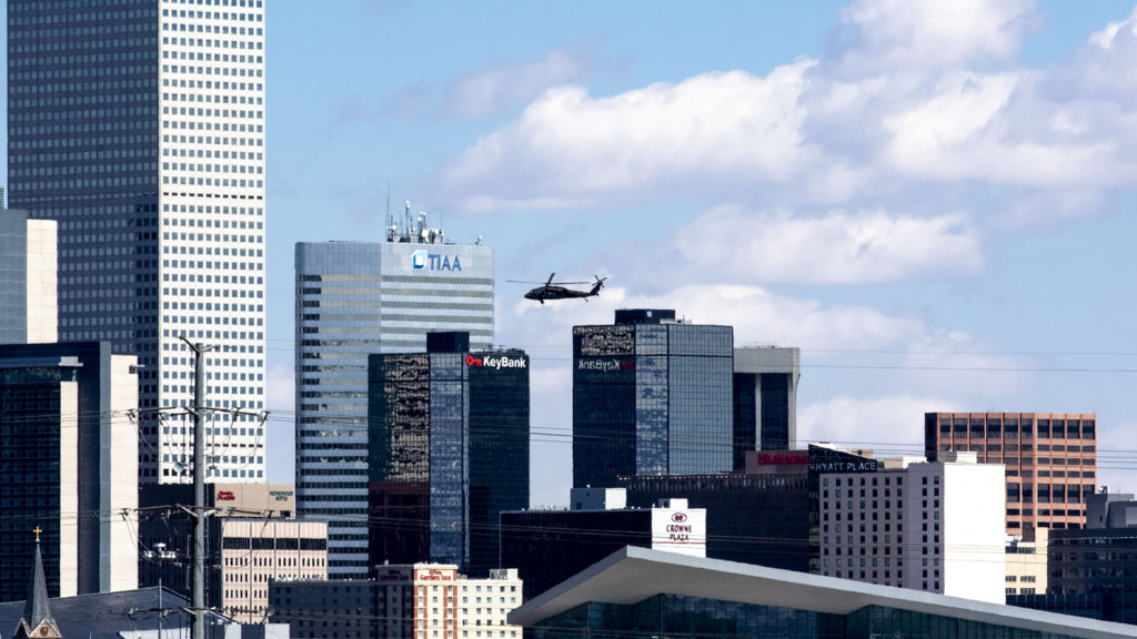 A blackhawk helicopter carrying U.S. Army Lt. Gen. Todd Semonite flies over Denver toward the Colorado Convention Center. April 14, 2020. (Kevin J. Beaty/Denverite)
