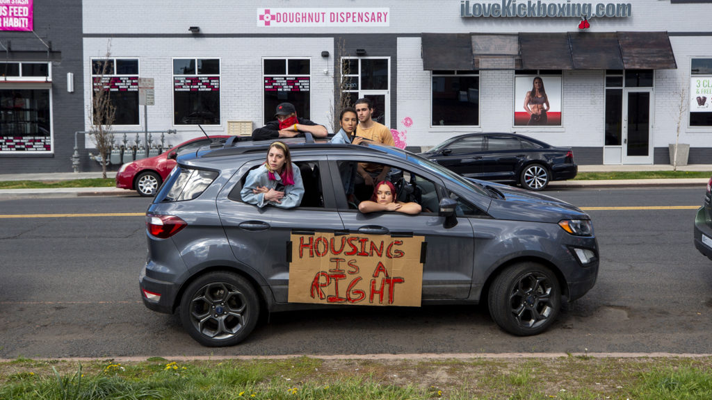 Protesters listen to instructions on how to protest via caravan before leaving to demand a rent and mortgage pause, among other things. April 25, 2020. (Kevin J. Beaty/Denverite)