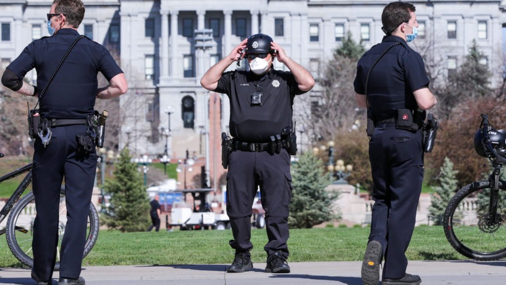 Denver Police officers on duty April 20 in Civic Center Park, standing where in recent years crowds filled the park to celebrate all things weed on 4/20. (Hart Van Denburg/CPR News)
