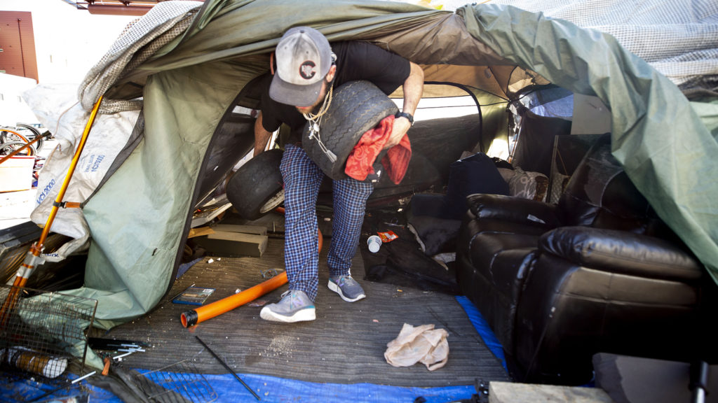 Dustin Fitzpatrick packs up his home in Five Points at the orders of Denver Police. May 7, 2020. (Kevin J. Beaty/Denverite)