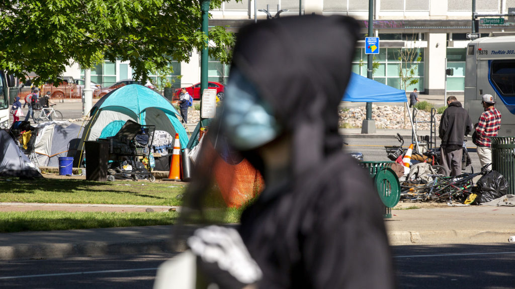 Denver Democratic Socialists, dressed as grim reapers, protest a lack of eviction protections in front of the Capitol as people sleep in tents nearby. May 26, 2020. (Kevin J. Beaty/Denverite)