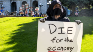 Protesters calling for a full re-opening of the state wait their turn to picket along Lincoln Street as Denver Democratic Socialists, dressed as grim reapers, protest a lack of eviction protections. May 26, 2020. (Kevin J. Beaty/Denverite)