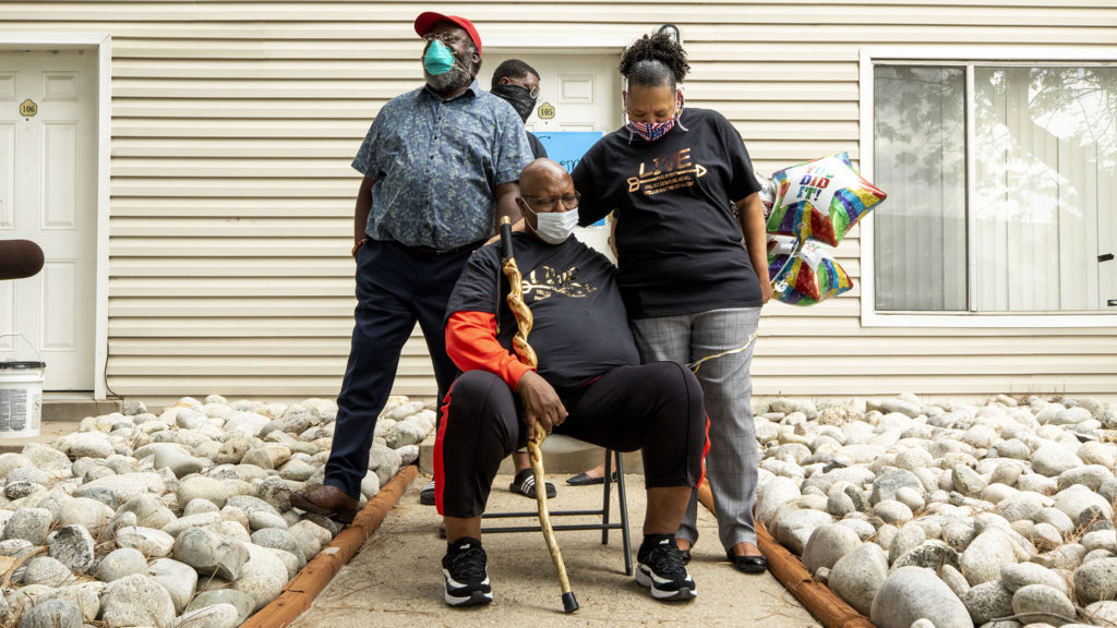 Pastor Terrance Hughes prays with his wife, Rachel, after three months in treatment and recovering from COVID-19. May 27, 2020. (Kevin J. Beaty/Denverite)