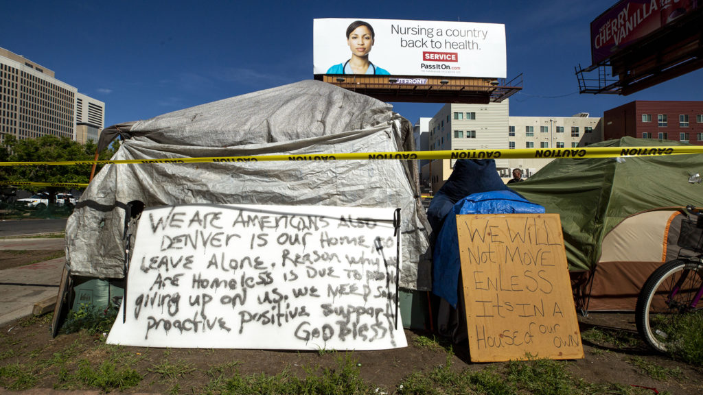 Signs posted at the encampments near the intersection of California and 21st Streets during a multi-agency cleanup. May 27, 2020. (Kevin J. Beaty/Denverite)