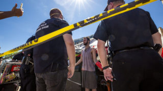 Dustin Fitzpatrick argues with authorities who threatened to take him to jail if he didn't move from an encampment near the intersection of California and 21st Streets. May 27, 2020. (Kevin J. Beaty/Denverite)