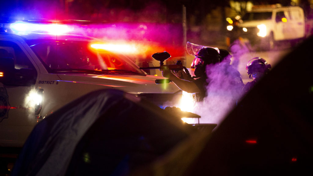 Denver police aim paintball guns filled with pepper balls as protesters react to the killing of George Floyd by the state Capitol. May 28, 2020. (Kevin J. Beaty/Denverite)