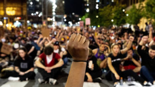 Khyra Parker raises her fist during nine minutes of silence during the sixth day of protests in reaction to the killing of George Floyd by Minneapolis police. June 2, 2020. (Kevin J. Beaty/Denverite)