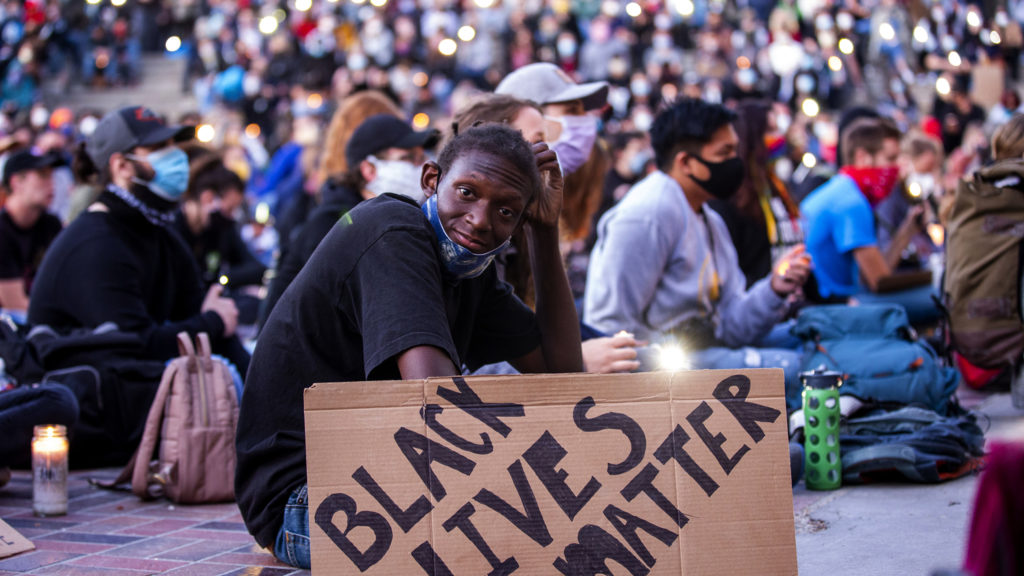 Malachi Mason holds up his protest sign during a vigil for George Floyd at Civic Center Park. June 9, 2020. (Kevin J. Beaty/Denverite)