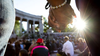 Melanie Crumb and Angela Jackson hold hands during a vigil for George Floyd at Civic Center Park. June 9, 2020. (Kevin J. Beaty/Denverite)