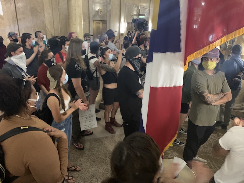 Protesters stand outside Mayor Michael Hancock's office on Wednesday, June 24, following a press conference at the City and County Building in Denver. (Esteban L. Hernandez/Denverite)