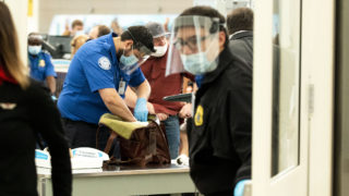 Face shields abound at the TSA checkpoint at Denver International Airport. July 7, 2020.
