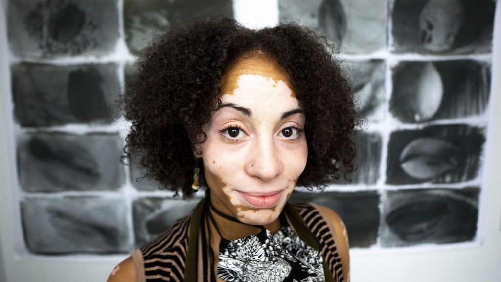 Jasmine Abena Colgan and her work on display at the Leon Gallery. City Park West, July 16, 2020. (Kevin J. Beaty/Denverite)